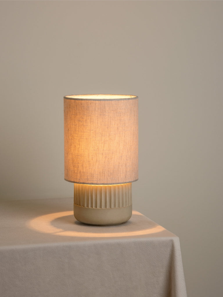 Enza Small Warm White Ribbed Concrete Table Lamp.